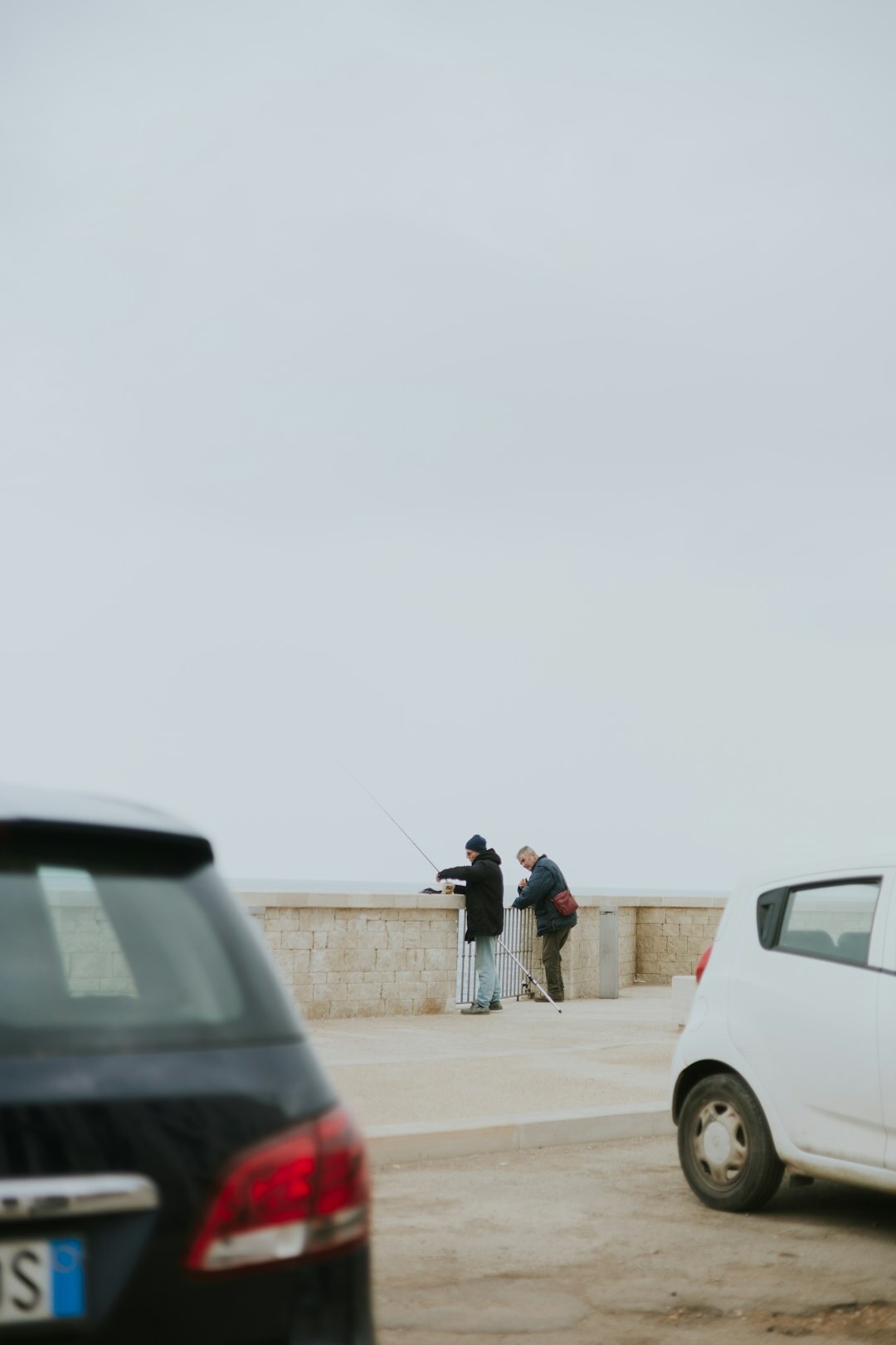 Two people exchanging car keys outdoors